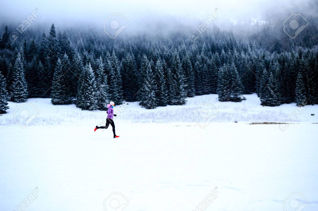 Sport, fitness inspiration and motivation. Young happy woman cross country running in mountains on snow, winter day. Female trail runner jogging exercising outdoors. - 43899694 Sport, fitness inspiration and motivation. Young happy woman cross country running in mountains on snow, winter day. Female trail runner jogging exercising outdoors. - 43899694