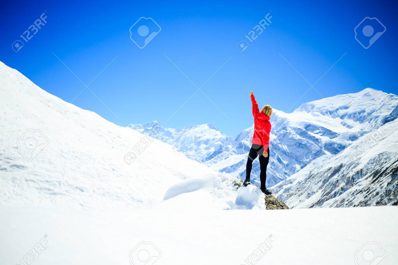 Young happy woman hiker successful on mountain peak summit in winter mountains. Climbing inspiration and motivation, beautiful landscape. Fitness healthy lifestyle outdoors on snow in Himalayas, Nepal. - 45775471 Young happy woman hiker successful on mountain peak summit in winter mountains. Climbing inspiration and motivation, beautiful landscape. Fitness healthy lifestyle outdoors on snow in Himalayas, Nepal. - 45775471