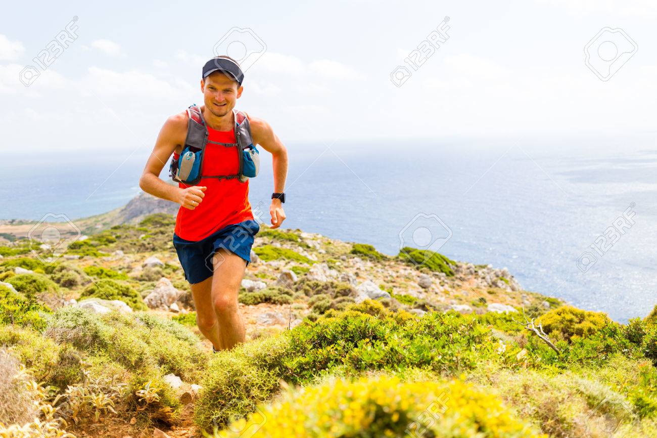 Trail running man, happy cross country runner in inspirational mountains landscape on beautiful day. Training and working out person jogging and exercising outdoors in nature, rocky footpath on Crete, Greece - 45886341 Trail running man, happy cross country runner in inspirational mountains landscape on beautiful day. Training and working out person jogging and exercising outdoors in nature, rocky footpath on Crete, Greece - 45886341