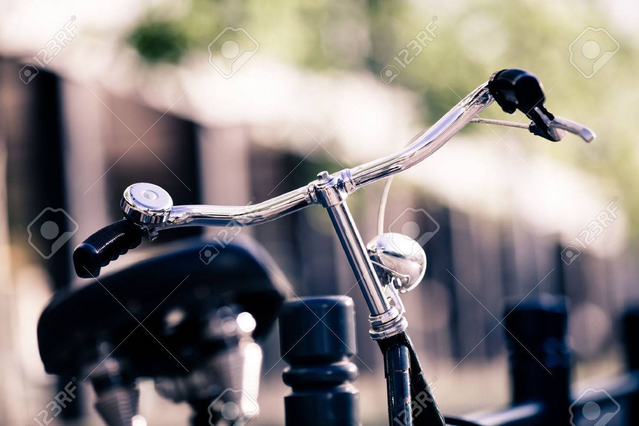 Vintage old city bike colorful retro light and handlebar on street, alternative ecology transportation, commute on classic bicycle in urban environment, blurred beautiful bokeh background. Selective focus on handlebar. - 47322800 Vintage old city bike colorful retro light and handlebar on street, alternative ecology transportation, commute on classic bicycle in urban environment, blurred beautiful bokeh background. Selective focus on handlebar. - 47322800