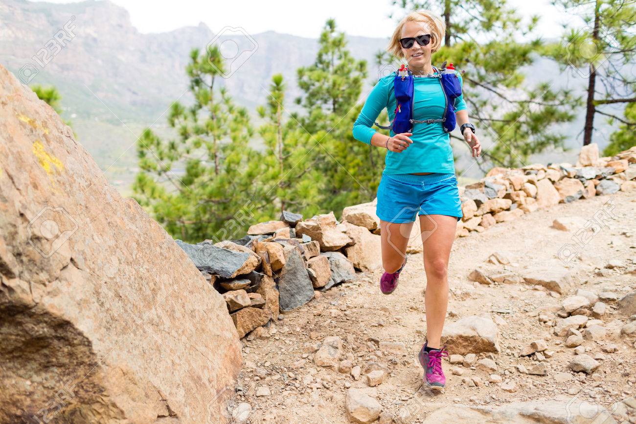 Trail runner woman cross country running in mountains, inspirational landscape. Training and working out runner jogging and enjoy outdoors in nature, rocky footpath on Canary Islands, Spain - 52377482 Trail runner woman cross country running in mountains, inspirational landscape. Training and working out runner jogging and enjoy outdoors in nature, rocky footpath on Canary Islands, Spain - 52377482