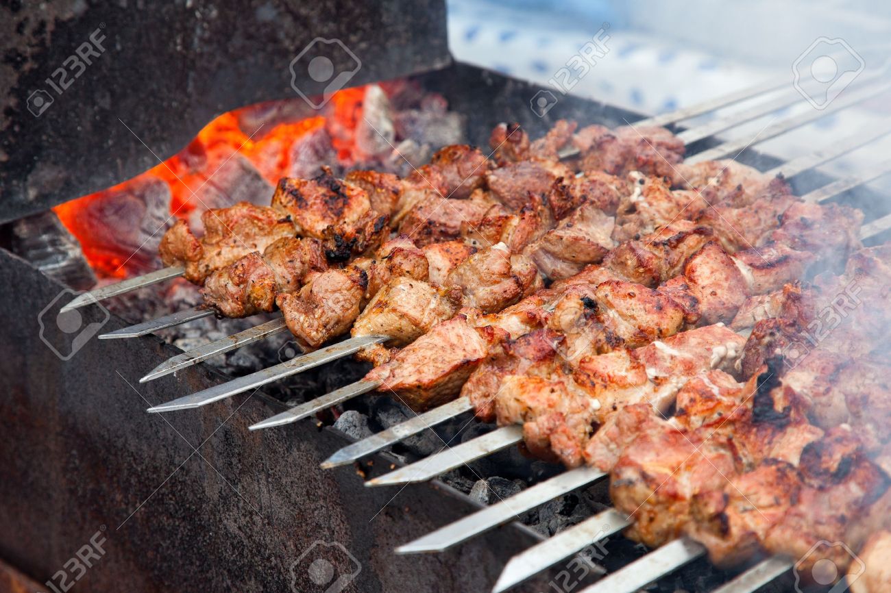 Appetizing fresh meat shish kebab shashlik prepared on a grill wood coal, outdor - 12515800 Appetizing fresh meat shish kebab shashlik prepared on a grill wood coal, outdor - 12515800