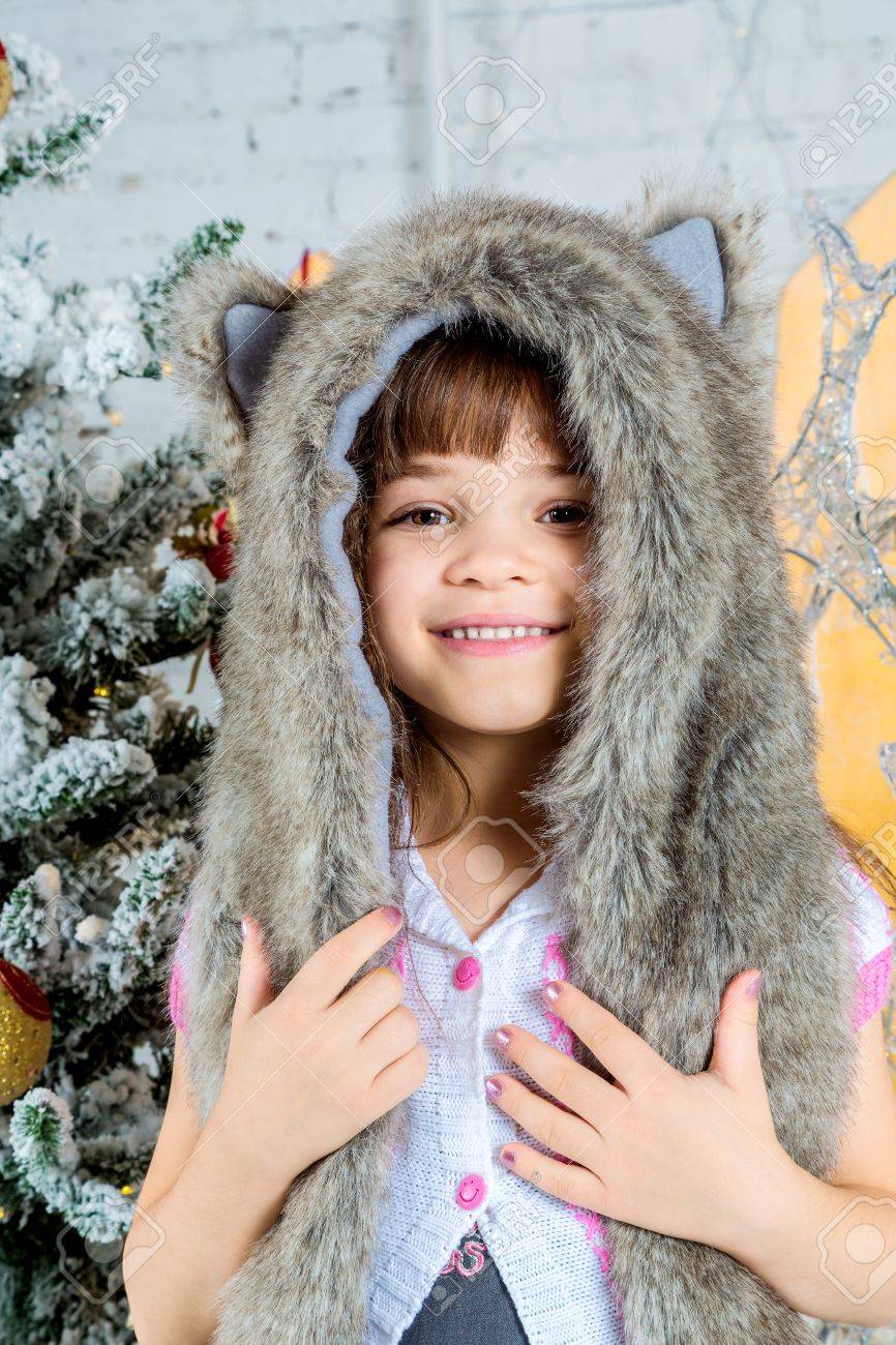 Funny Cute Baby Girl With Big Blue Eyes Wearing A Huge Fur Winter