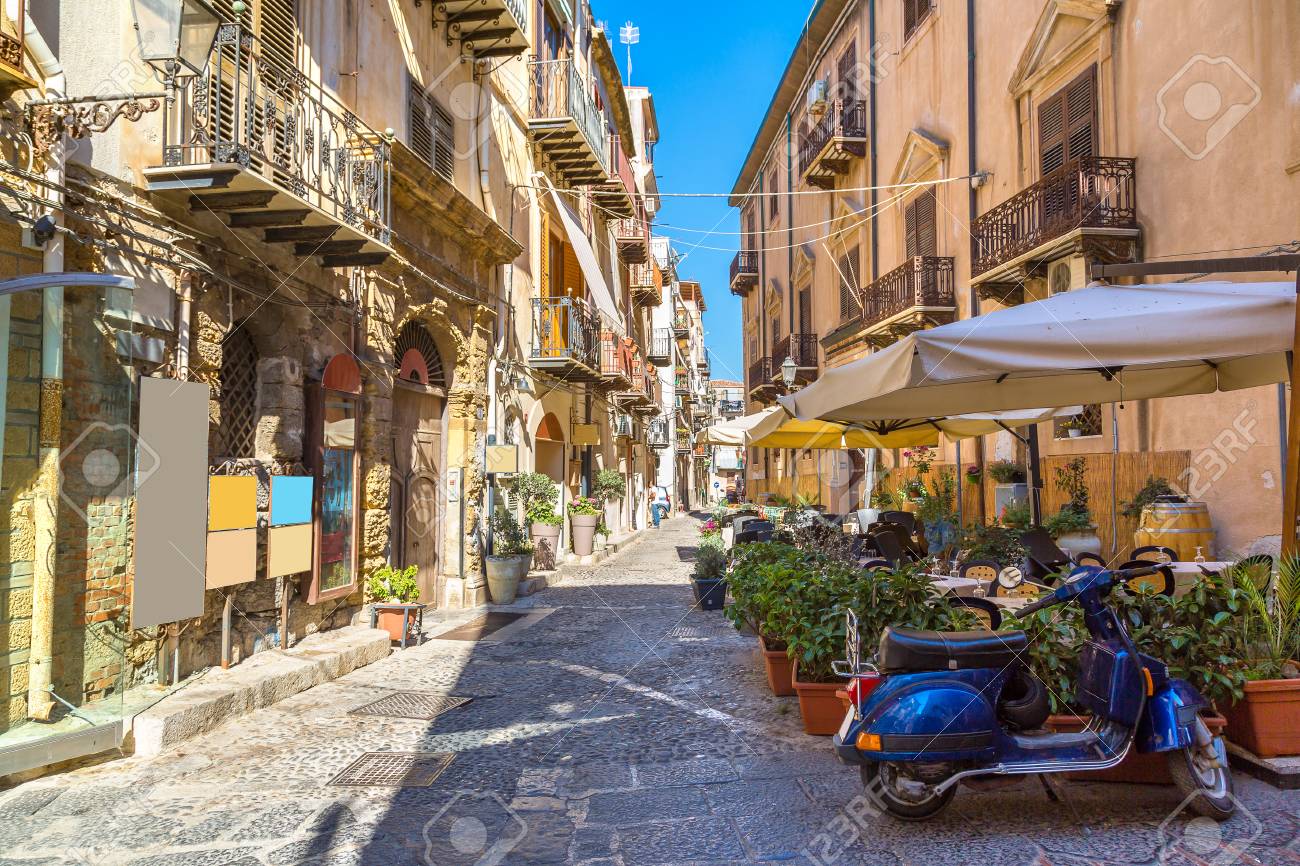 Narrow street in the old town of Cefalu in Sicily, Italy in a beautiful summer day - 84958035 Narrow street in the old town of Cefalu in Sicily, Italy in a beautiful summer day - 84958035