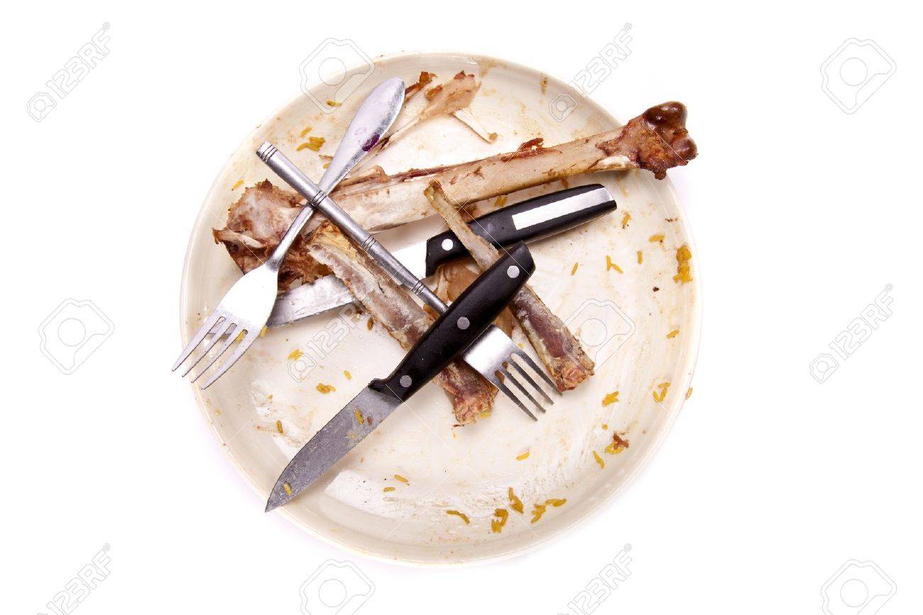 A stack of dirty plates with bones. - 8457332 A stack of dirty plates with bones. - 8457332