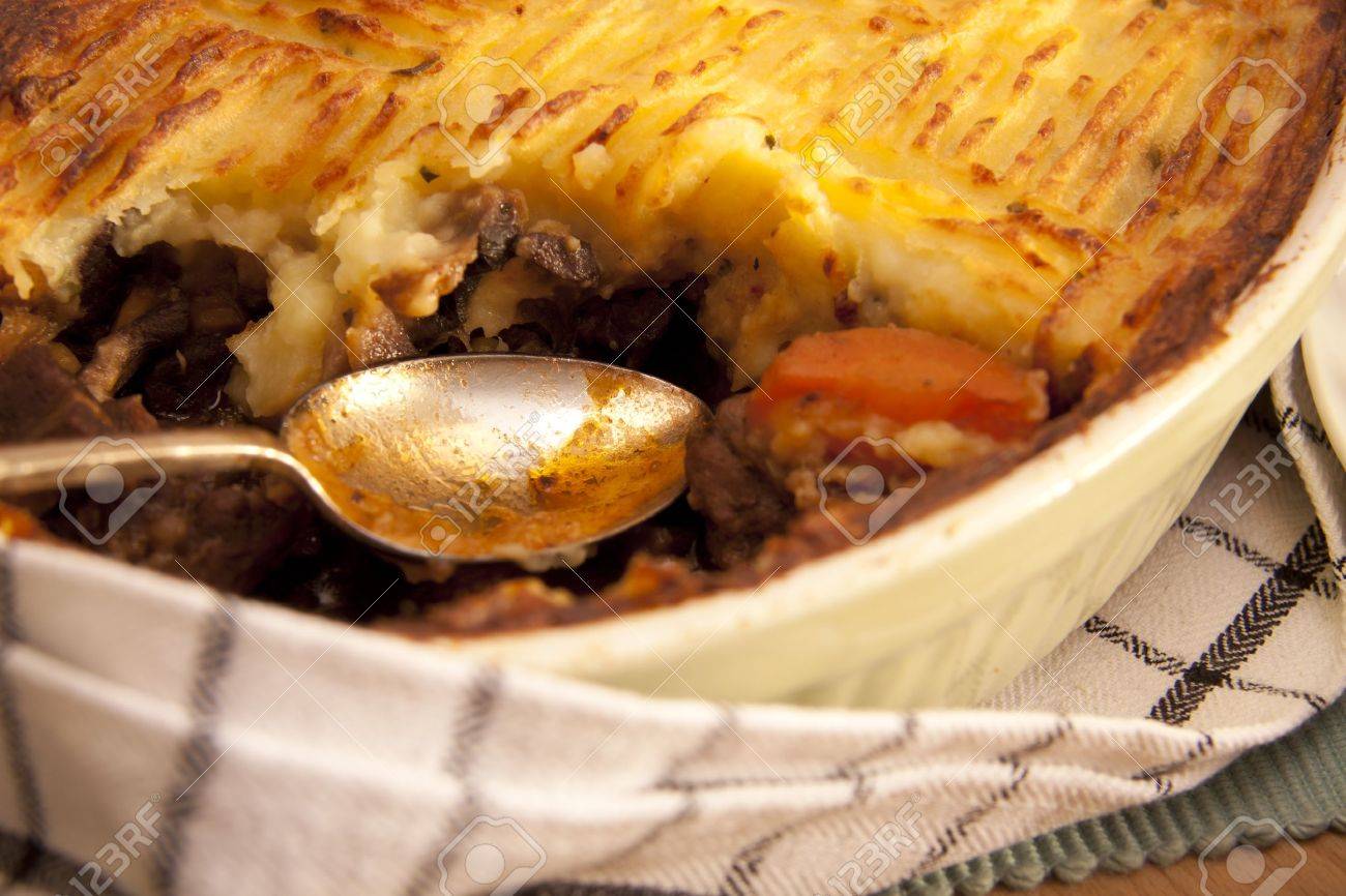 A delicious home made meat pie on a wooden table that makes your mouth water. - 9660292 A delicious home made meat pie on a wooden table that makes your mouth water. - 9660292