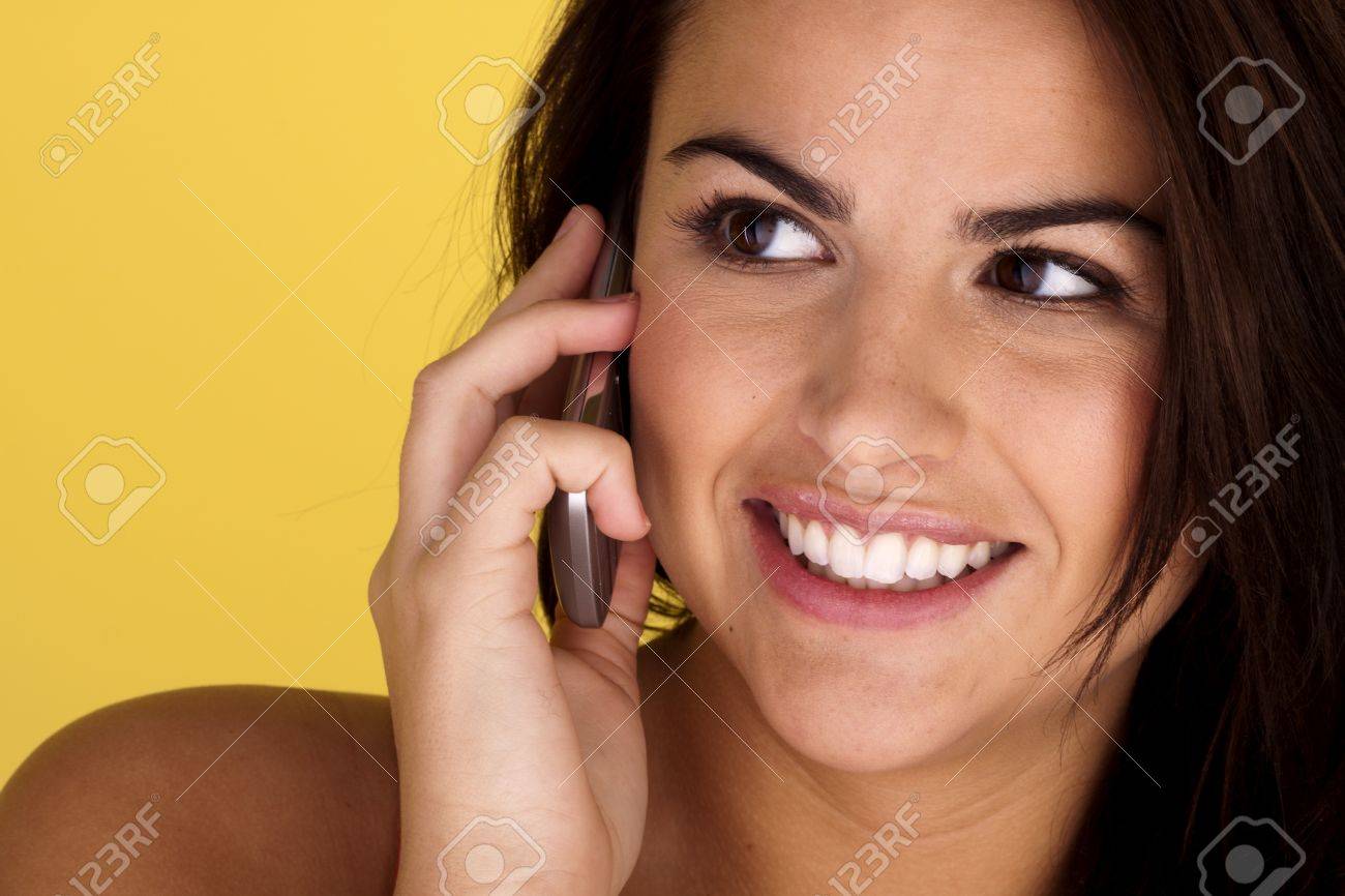 A cheerful and happy young woman is talking on her mobile cell phone. - 11543988 A cheerful and happy young woman is talking on her mobile cell phone. - 11543988
