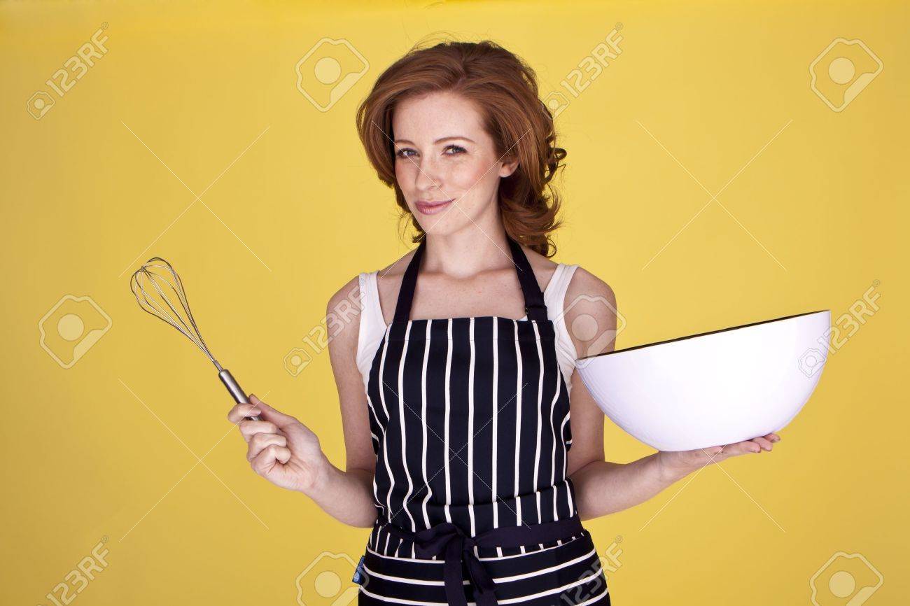 An attractive housewife is preparing a mixture for baking. - 12100532 An attractive housewife is preparing a mixture for baking. - 12100532