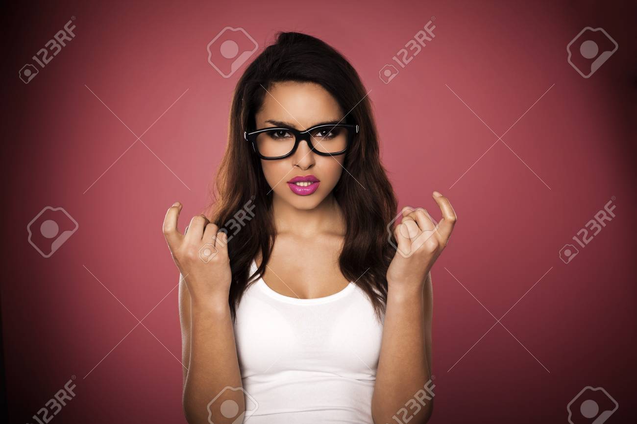 A beautiful woman with a funny expression wearing glasses on a pink background - 18737653 A beautiful woman with a funny expression wearing glasses on a pink background - 18737653