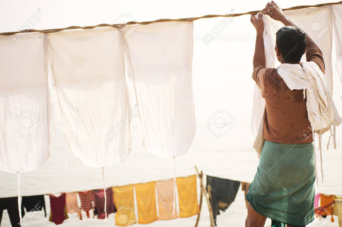 Indian Old Man Hang The Wash On A Clothesline Stock Photo, Picture and  Royalty Free Image. Image 24694706., image size:1300x866