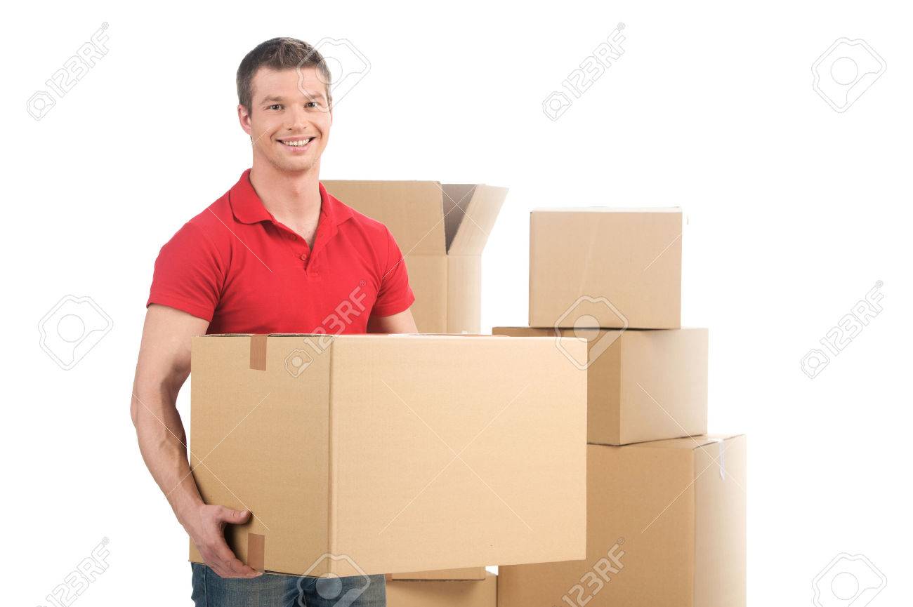 man holding moving box and smiling at camera. young man carrying carton boxes - 32577525 man holding moving box and smiling at camera. young man carrying carton boxes - 32577525