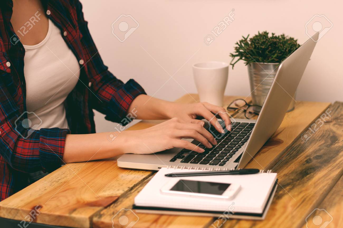 woman freelancer student or blogger typing on computer sitting at