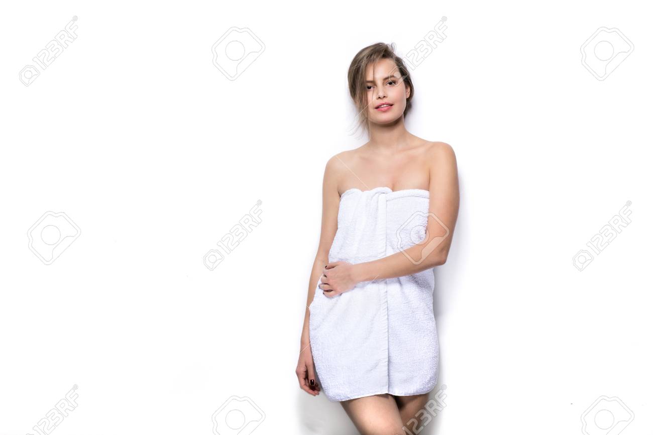 Beautiful Young Woman With Bath Towel On The Body Against A White Wall Stock Photo Picture And Royalty Free Image Image