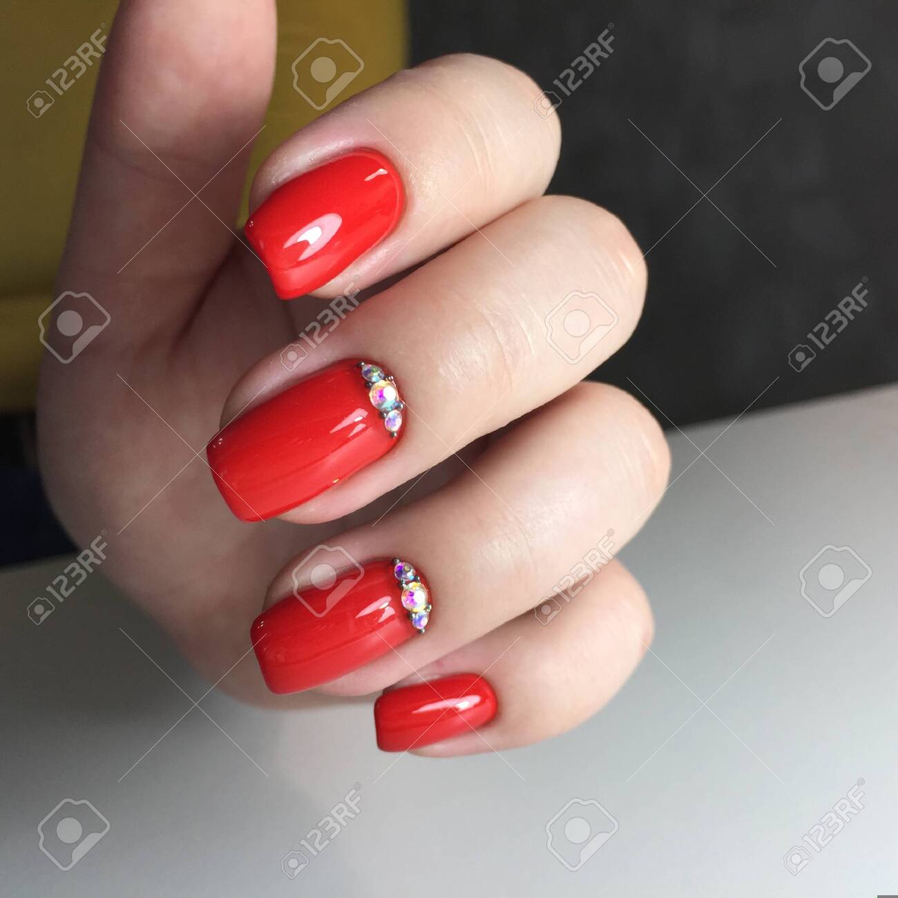 Closeup photo of a beautiful female hands with red nail.Beautiful female hands with red manicure on a dark background - 143083362 Closeup photo of a beautiful female hands with red nail.Beautiful female hands with red manicure on a dark background - 143083362