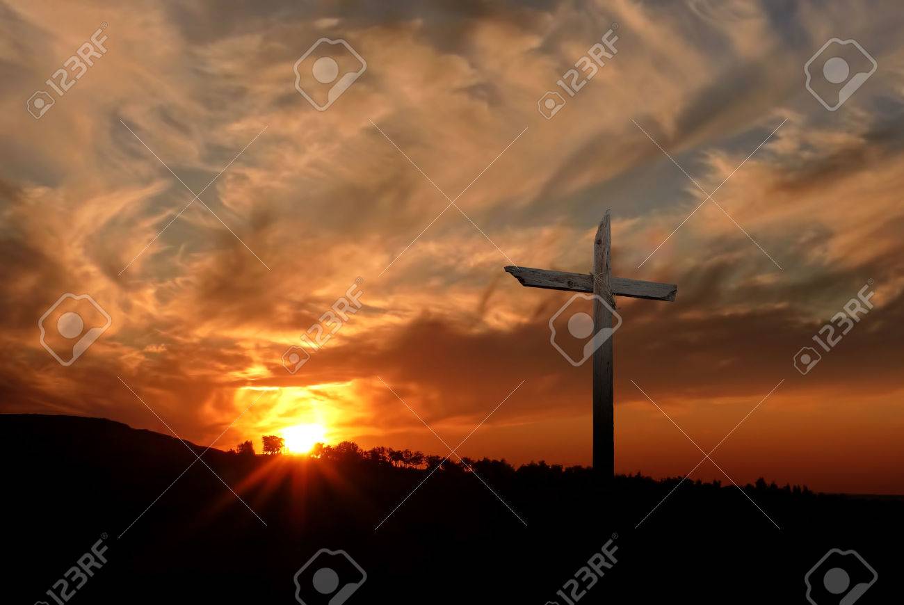 Silhouette of Christian cross at sunrise or sunset with light rays - 53518318 Silhouette of Christian cross at sunrise or sunset with light rays - 53518318