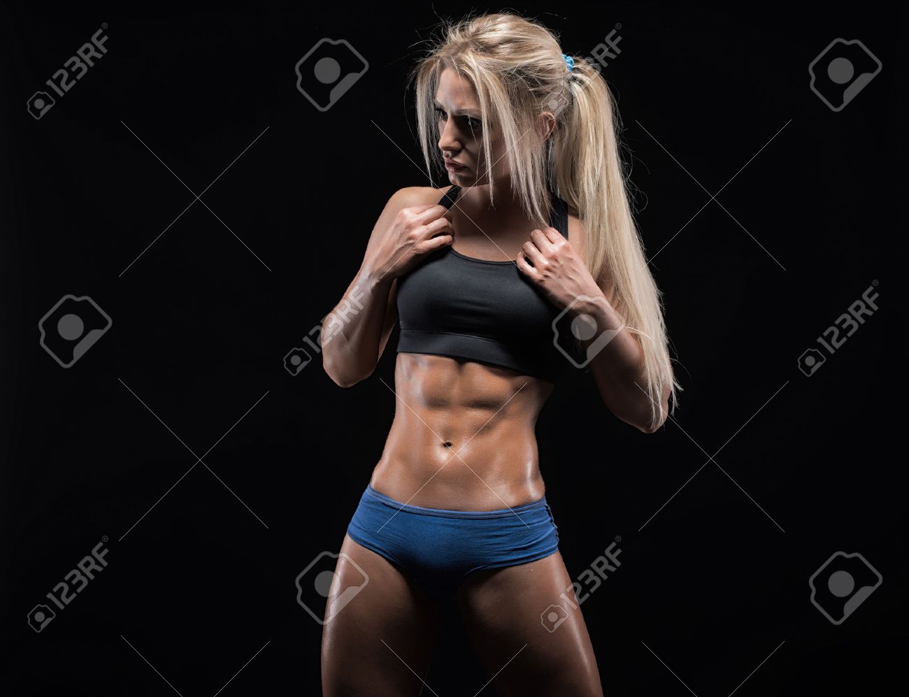 Young Fitness Woman Showing Her Perfect Sculpted Muscular And Tight Body  Stock Photo, Picture and Royalty Free Image. Image 49463289.