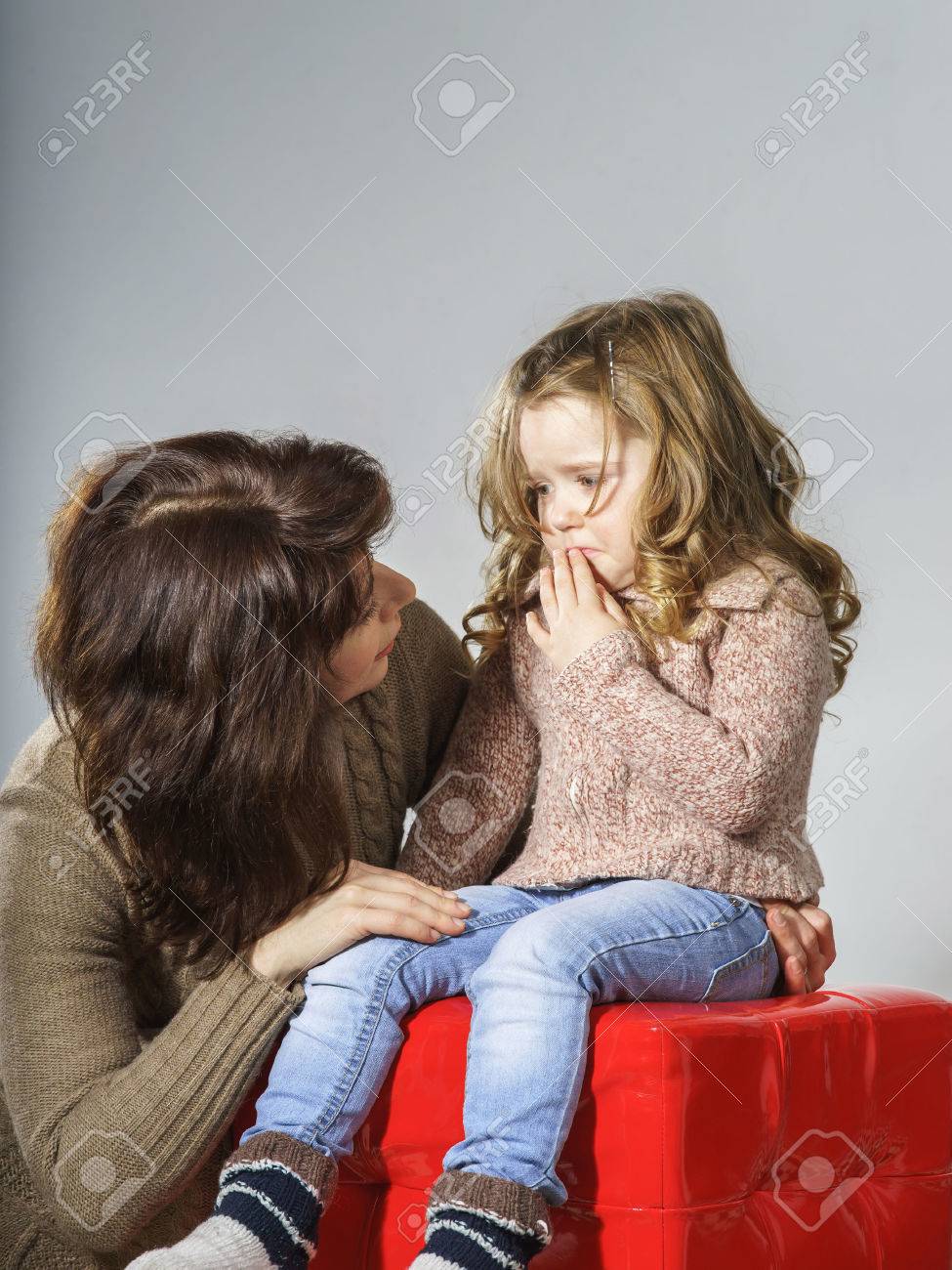 Mother reassuring little daughter. She is distracted and crying - 25152203 Mother reassuring little daughter. She is distracted and crying - 25152203