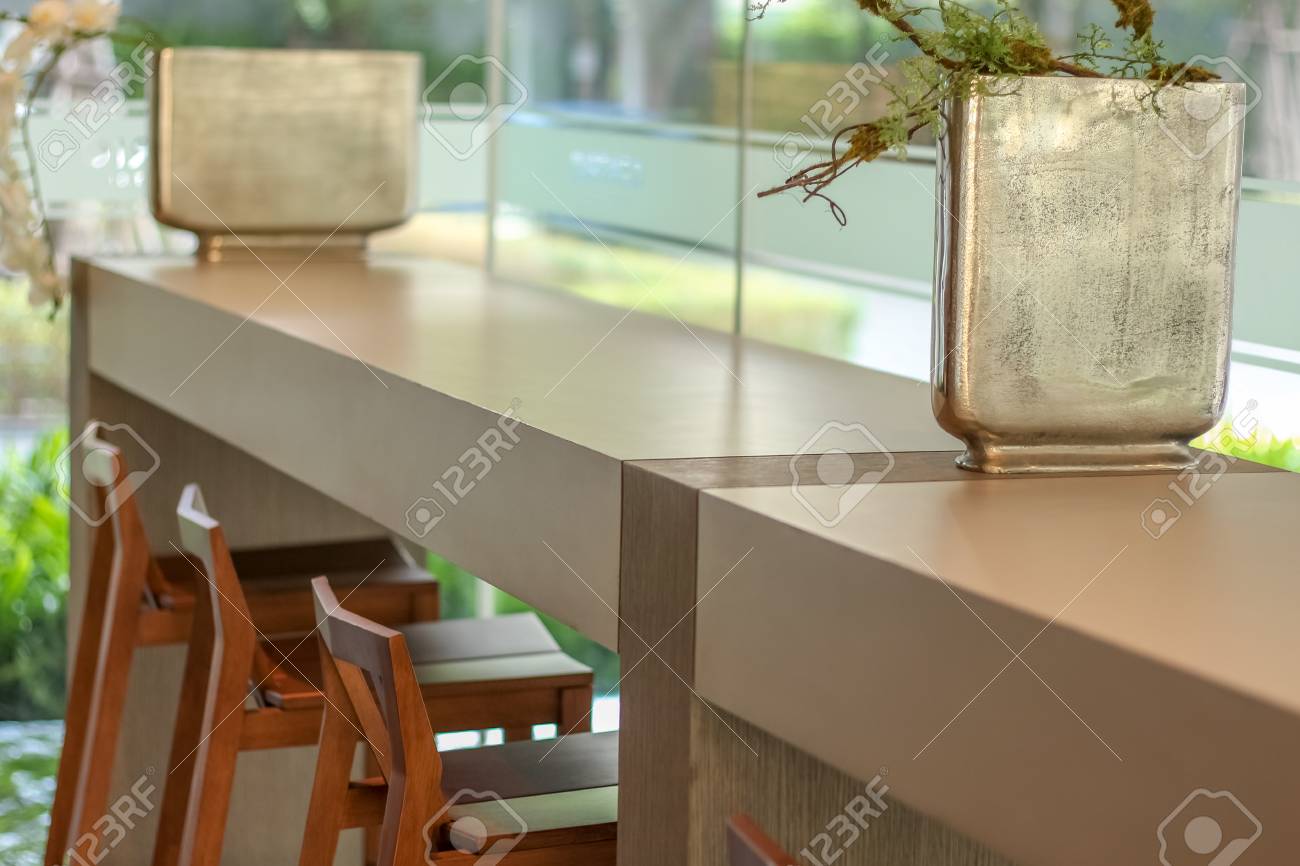 View Of Bar Table With Chair Decorate With Silver Square Vase