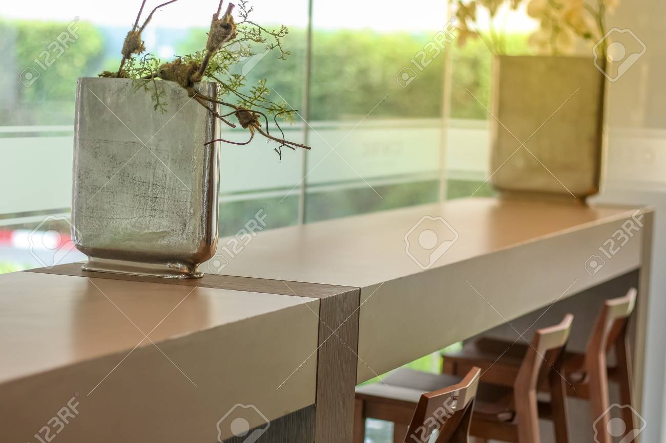 View Of Bar Table With Chair Decorate With Silver Square Vase