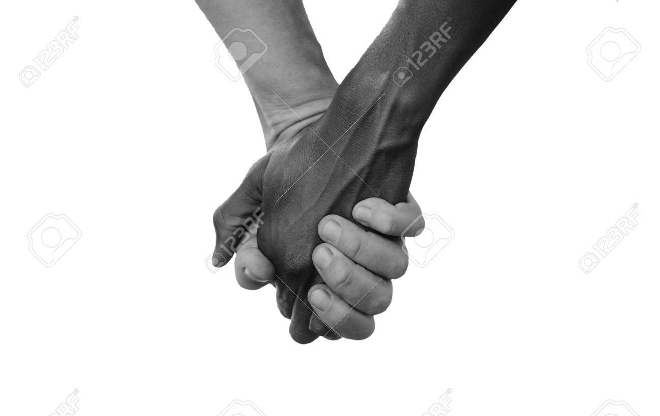 Black and white hold hands for africa union peace love a beautiful shot with lots of possible background symbols no to racism