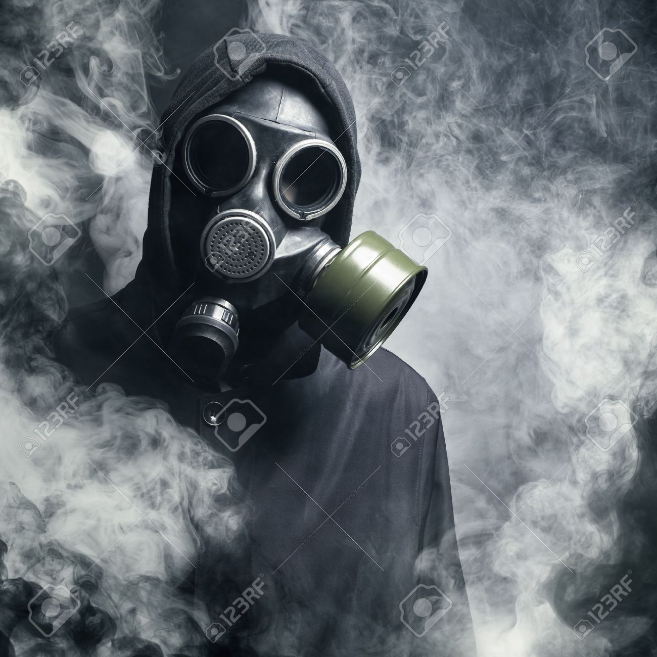 a man in a gas mask in the smoke black background stock photo