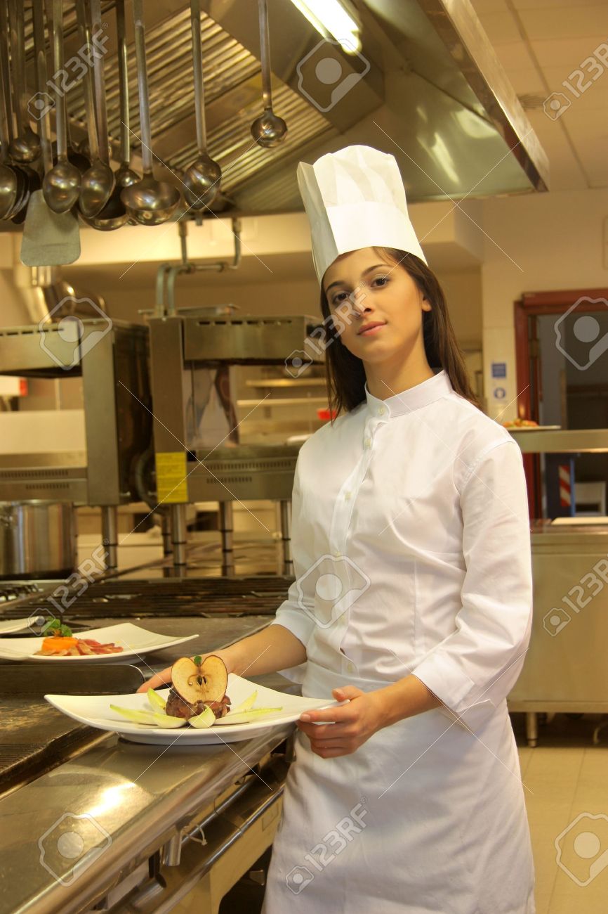 young cook in a kitchen of a restaurant stock photo picture and