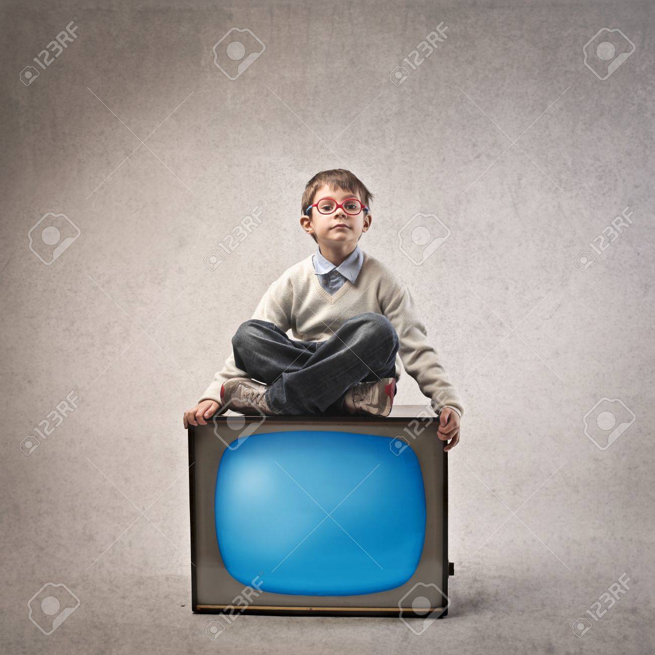 Baby Sitting With Legs Crossed On Old TV Stock Photo, Picture and Royalty  Free Image. Image 17238720.