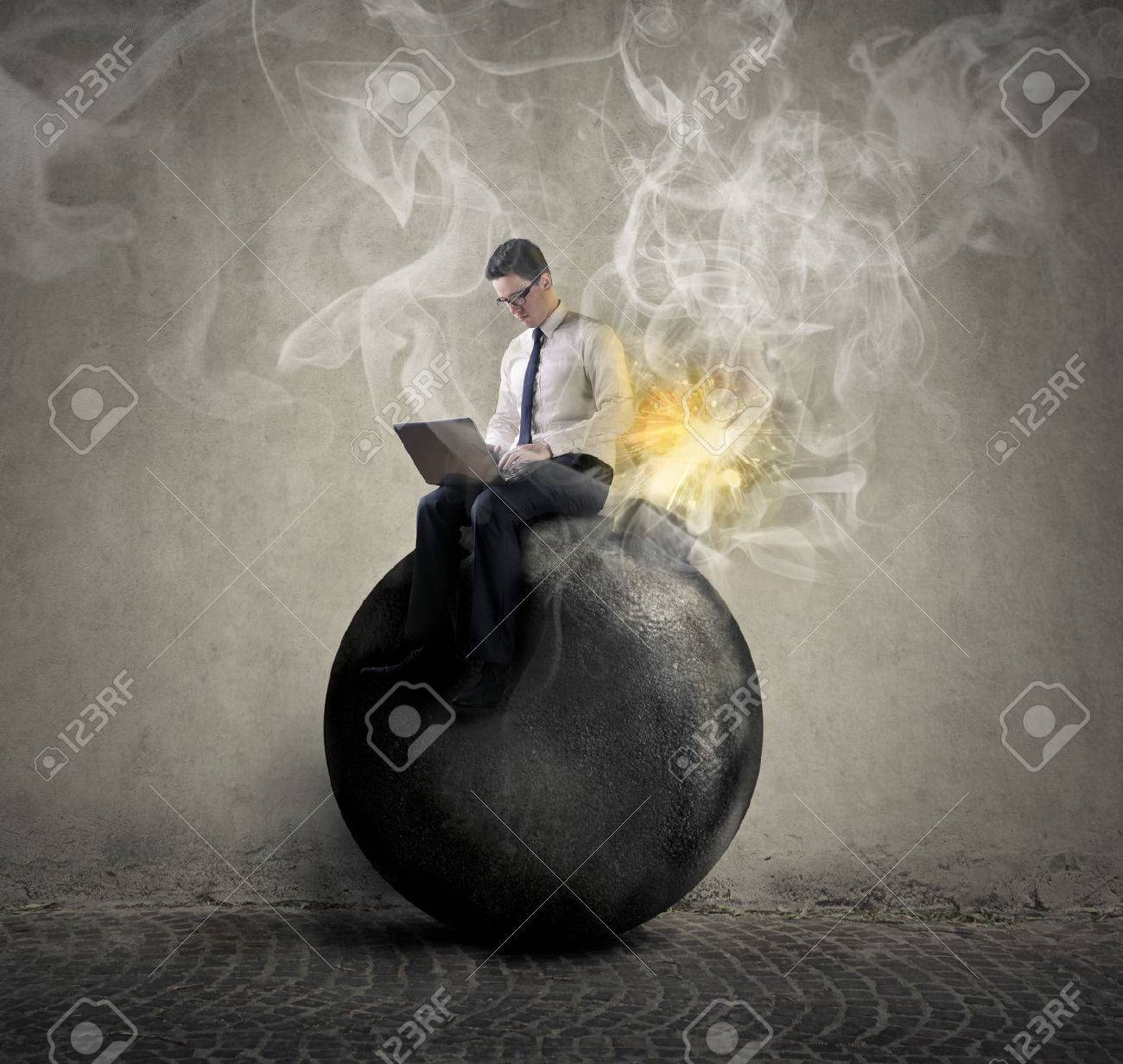 43966487-Businessman-sitting-on-a-bomb-Stock-Photo.jpg