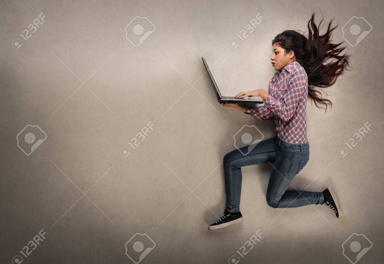 Girl jumping with her laptop - 59829728 Girl jumping with her laptop - 59829728