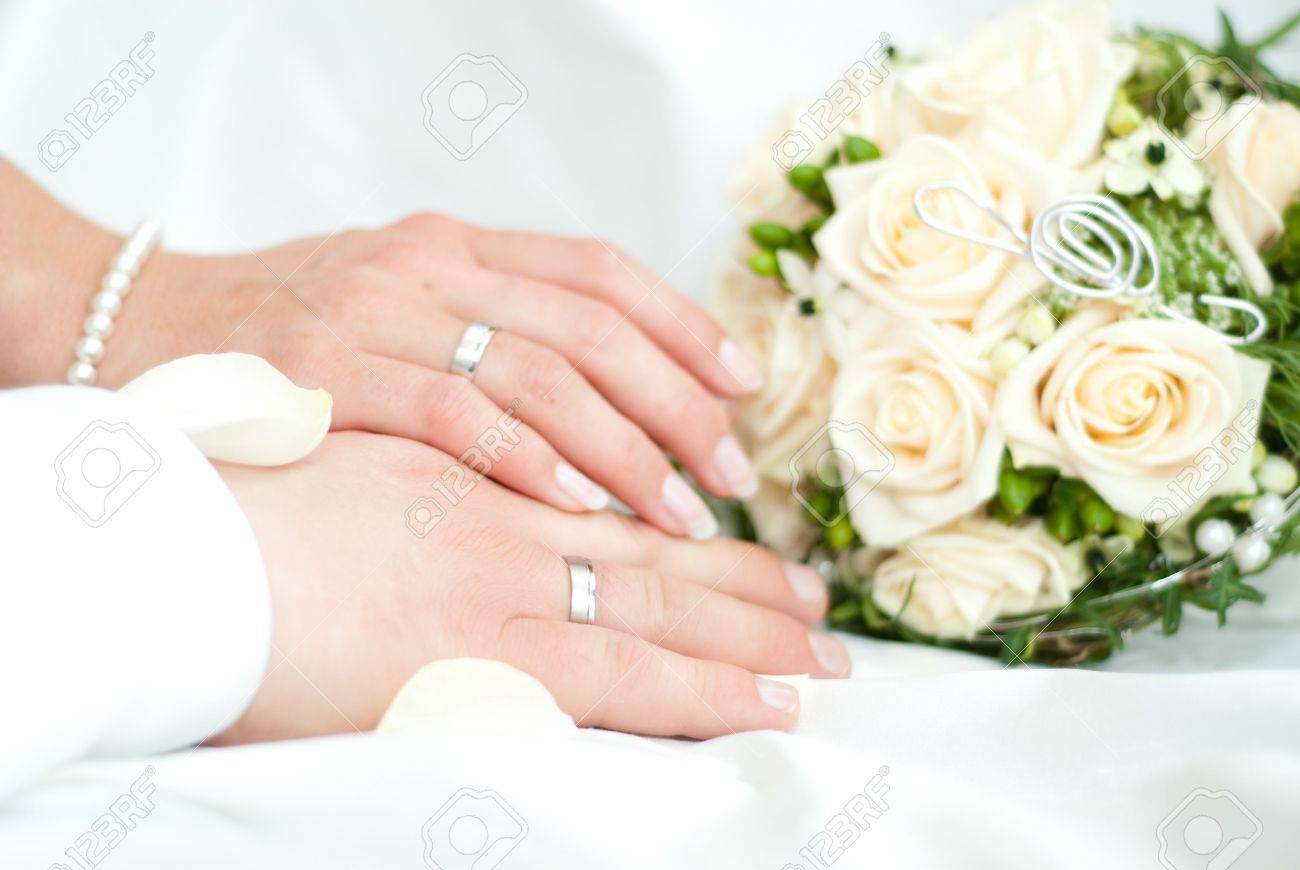 hands with wedding rings from a newly married couple and bouquet stock photo 6742382 - Wedding Rings On Hands hands with wedding rings from a newly married couple and bouquet stock photo 6742382 - Wedding Rings On Hands