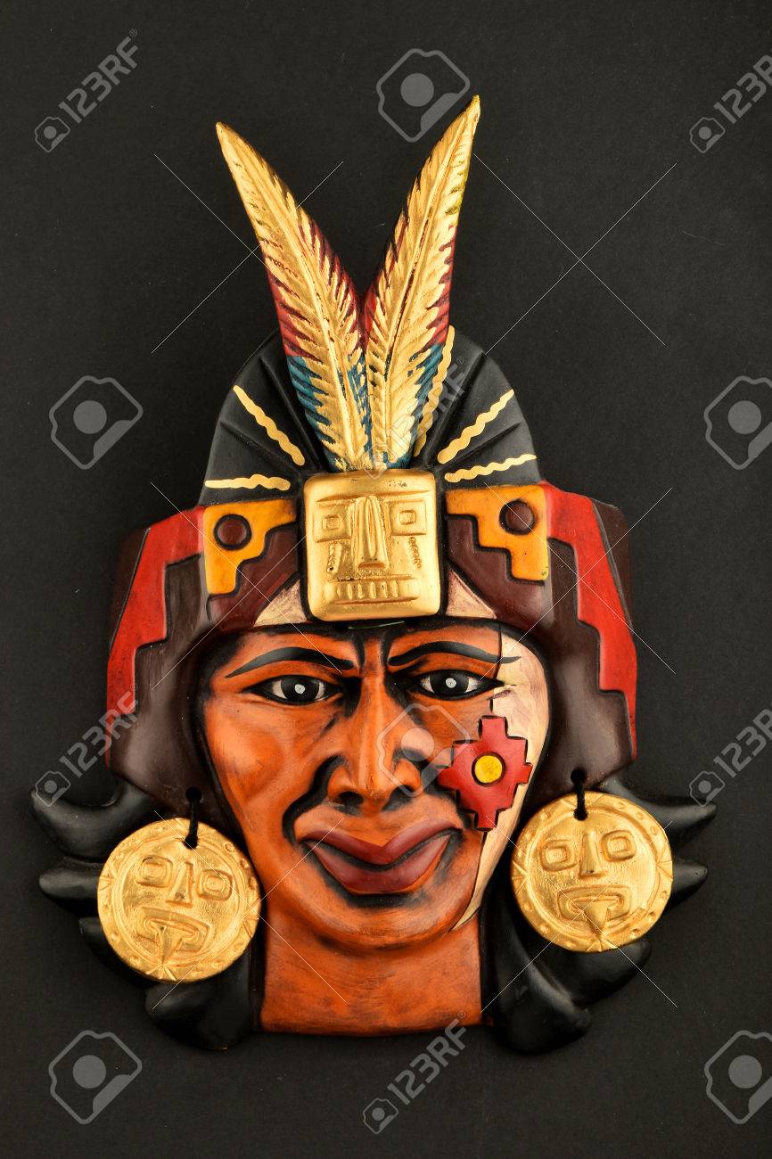 indian mayan aztec ceramic mask with feather isolated on black