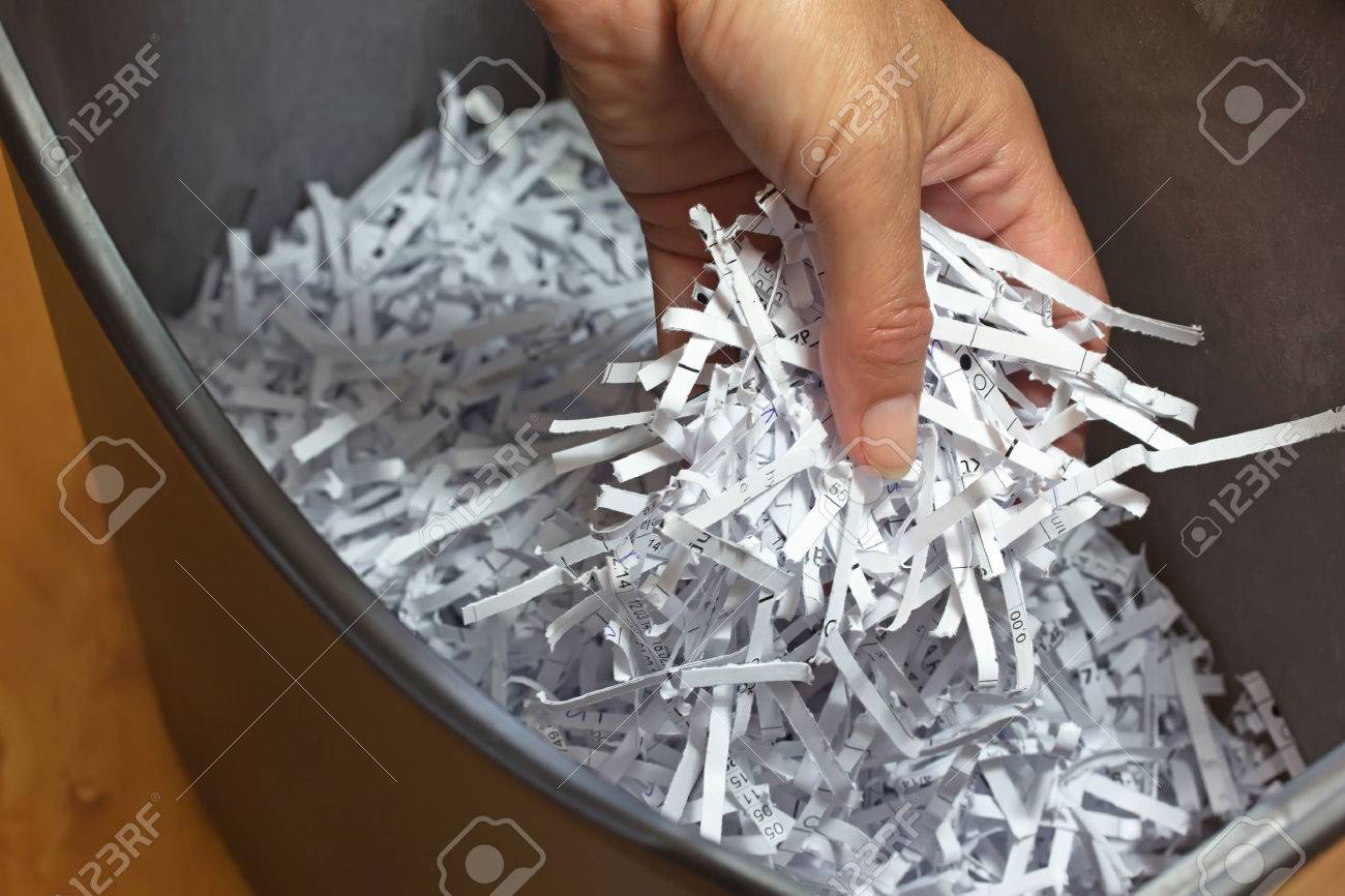 Hand holding shredded paper strips in a basket shredders - 30641229 Hand holding shredded paper strips in a basket shredders - 30641229