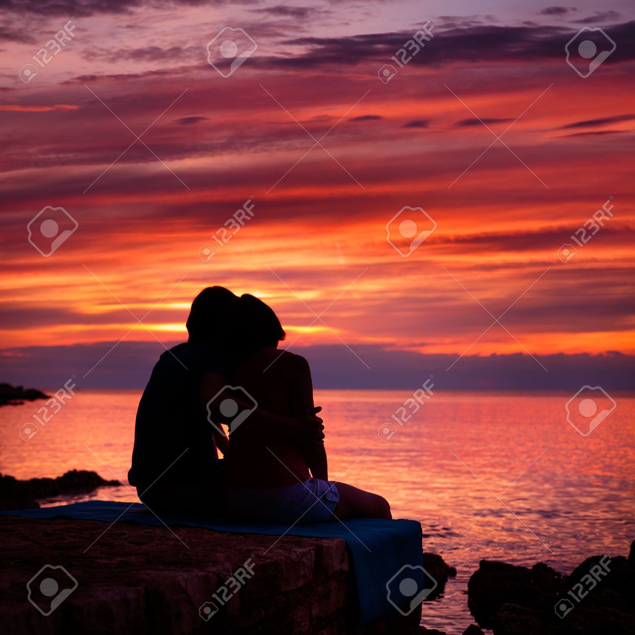 Silhouette of Romantic Couple Embracing and Watching Sea Sunset. Summer Nature Background. Copy Space. Love and Travel Concept. - 35751494 Silhouette of Romantic Couple Embracing and Watching Sea Sunset. Summer Nature Background. Copy Space. Love and Travel Concept. - 35751494