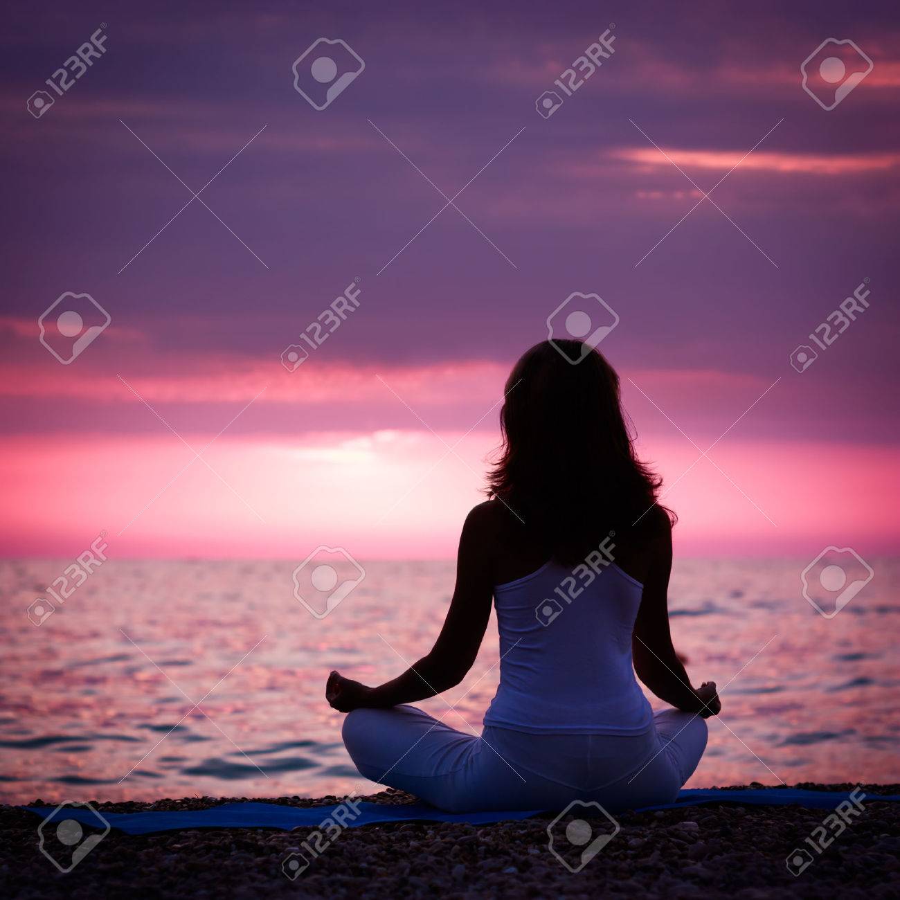 Silhouette of Woman Meditating in Lotus Position by the Sea at Sunset. Rear View. Nature Meditation Concept. - 38571906 Silhouette of Woman Meditating in Lotus Position by the Sea at Sunset. Rear View. Nature Meditation Concept. - 38571906