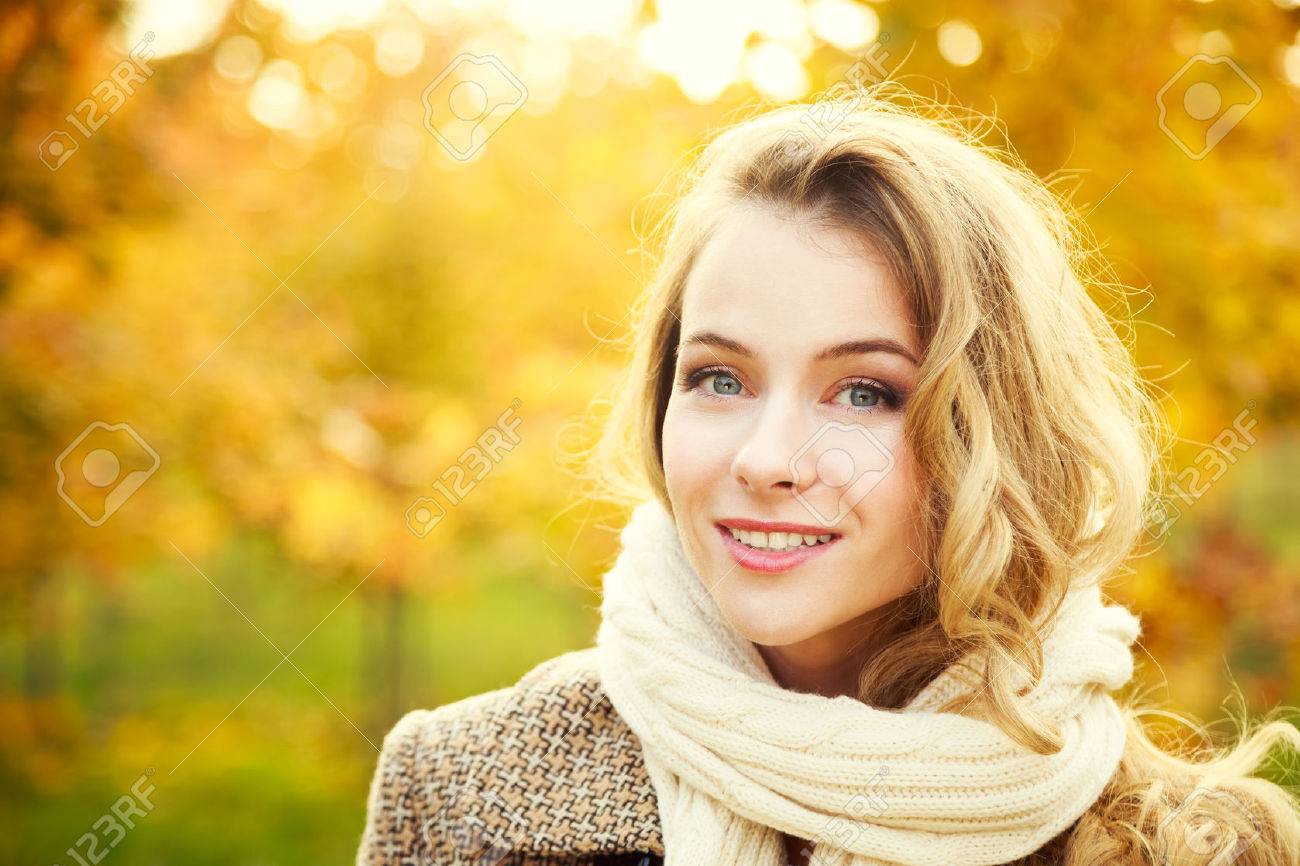 Young Fashion Woman on Autumn Background in Sunny Day. Smiling Happy Girl Portrait. Toned Photo with Copy Space. - 44152364 Young Fashion Woman on Autumn Background in Sunny Day. Smiling Happy Girl Portrait. Toned Photo with Copy Space. - 44152364