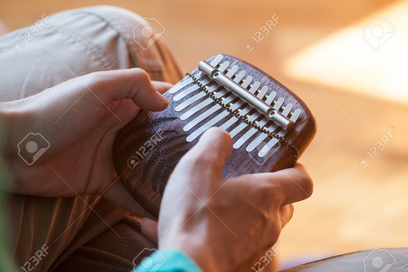 Man Holding Traditional African Musical Instrument Kalimba In