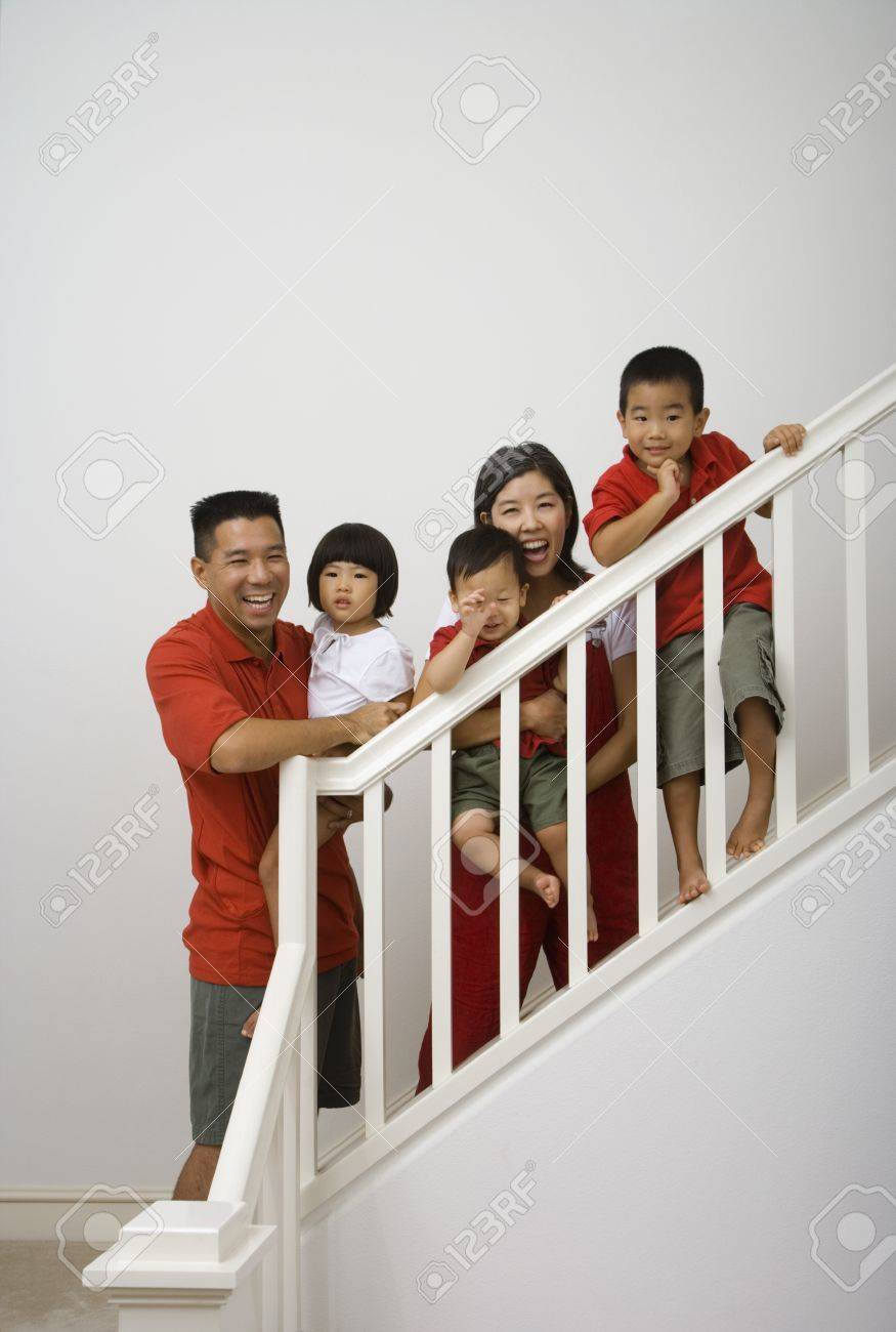 Portrait Of Asian Family On Stairs Stock Photo, Picture and