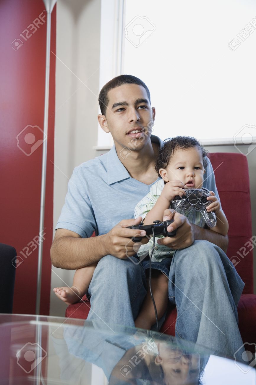 35545190-young-african-father-playing-video-games-with-baby-on-lap.jpg