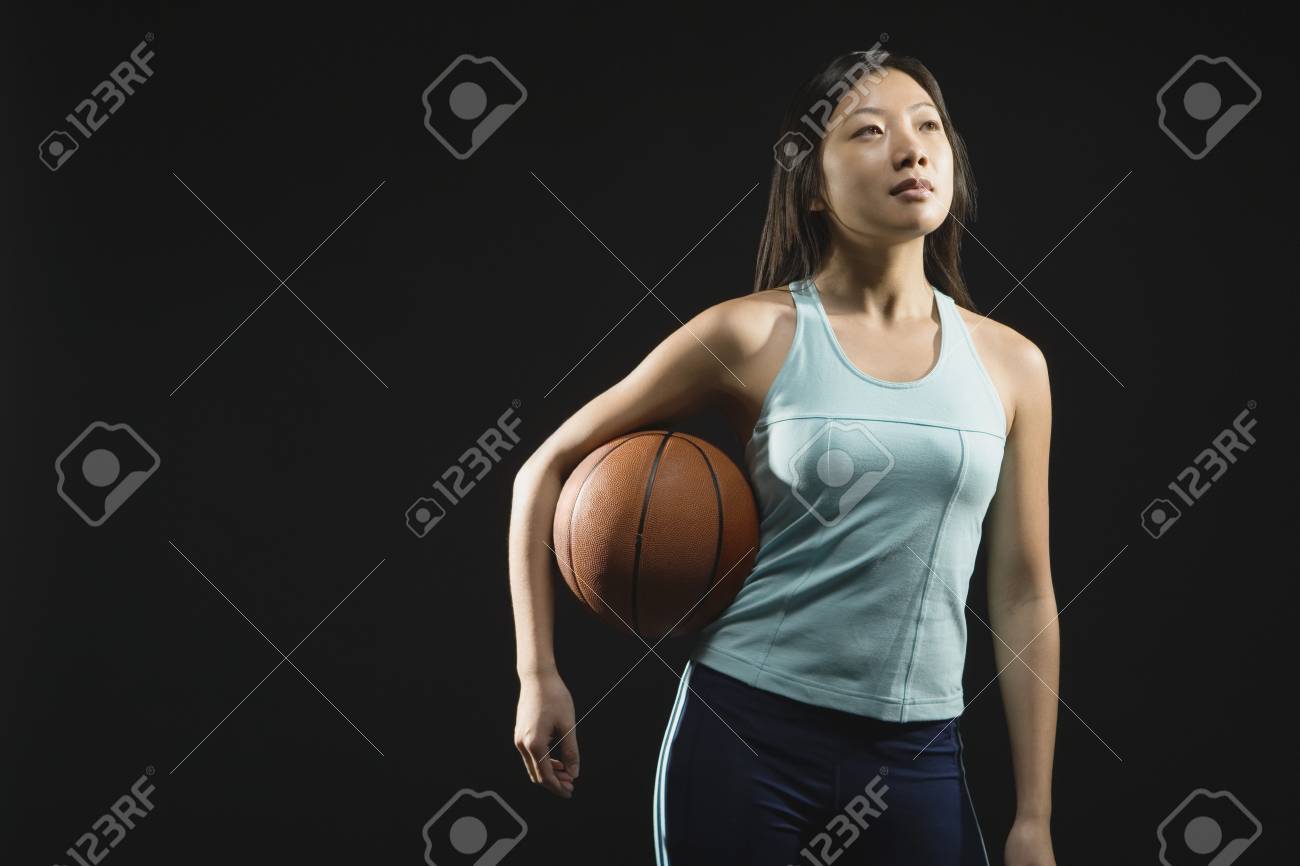 asian woman holding basketball stock photo picture and royalty free
