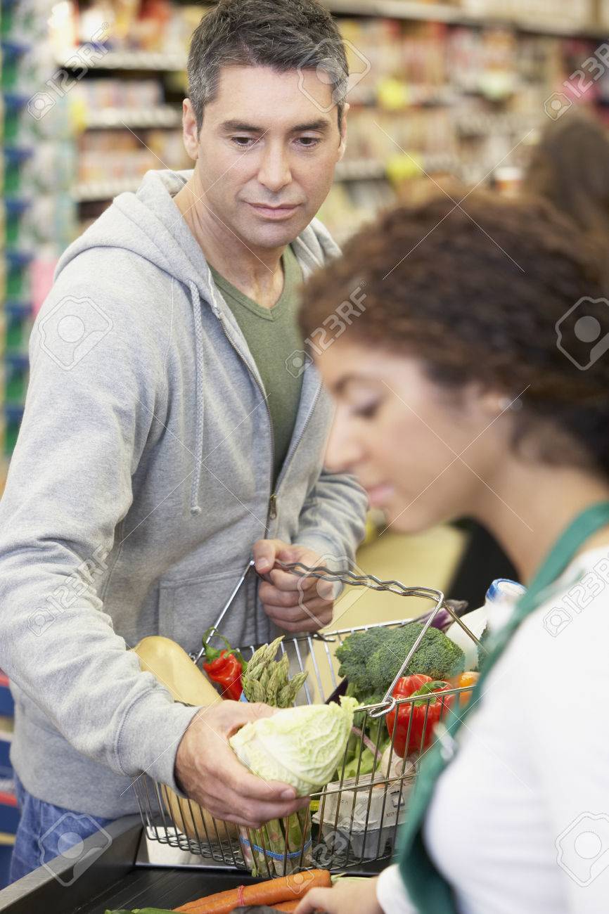 hispanic man checking out at grocery store stock photo picture and checking out