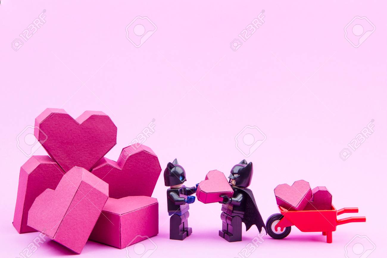 Nonthaburi, Thailand - January, 11, 2017 : Lego Batman Showing Love Give A  Paper Box Red Heart Shape To Lego Catwoman On Pink Background.Concept  Valentine's Day Stock Photo, Picture and Royalty Free Image. Image 69316564., image size:1300x866