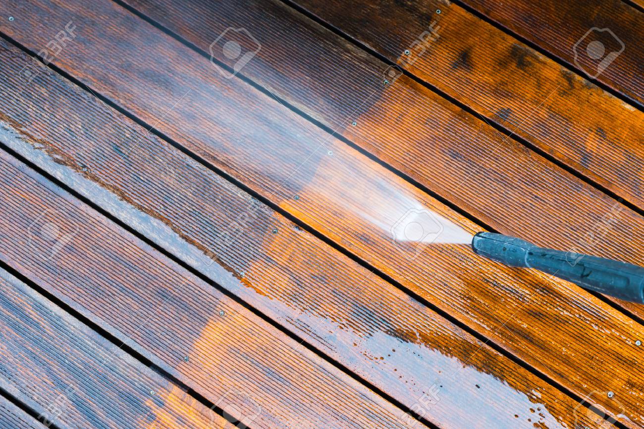 cleaning terrace with a power washer - high water pressure cleaner on wooden terrace surface - 69051695 cleaning terrace with a power washer - high water pressure cleaner on wooden terrace surface - 69051695