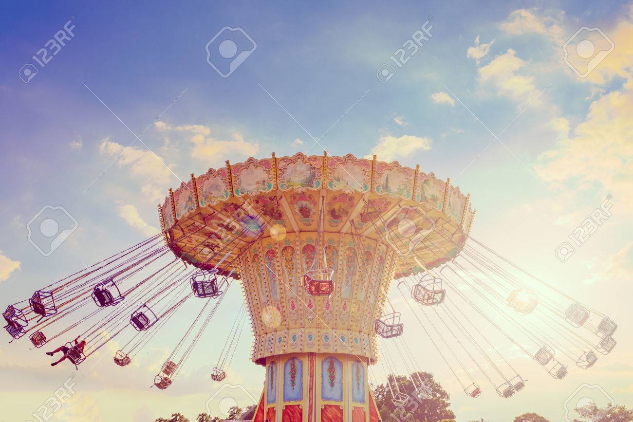 Wave Swinger ride against blue sky, vintage filter effects - a swinging carousel fair ride at dusk - 86187361 Wave Swinger ride against blue sky, vintage filter effects - a swinging carousel fair ride at dusk - 86187361