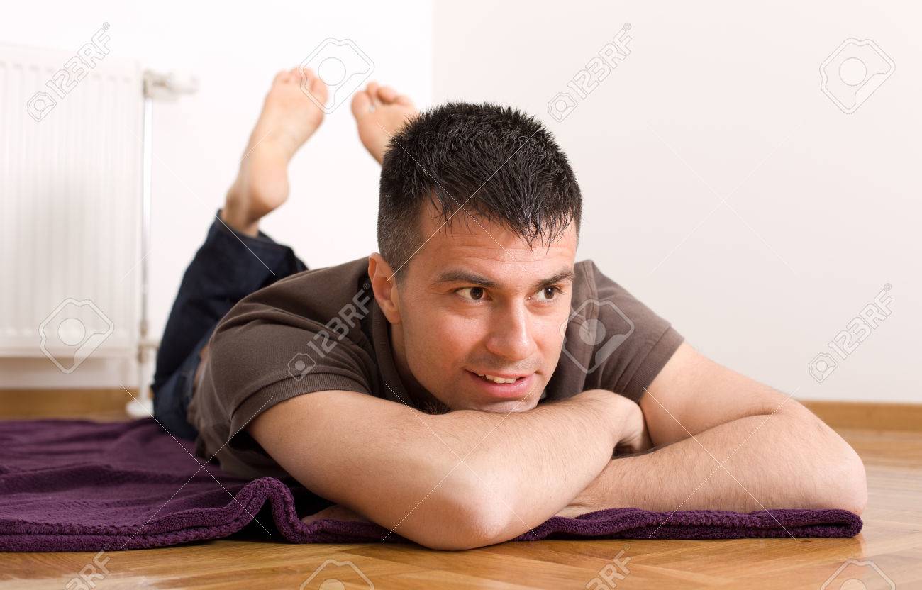 Close Up Of Attractive Man Lying On The Floor On Stomach With Stock Photo Picture And Royalty Free Image Image Close Up Of Attractive Man Lying On The Floor On Stomach With Stock Photo Picture And Royalty Free Image Image
