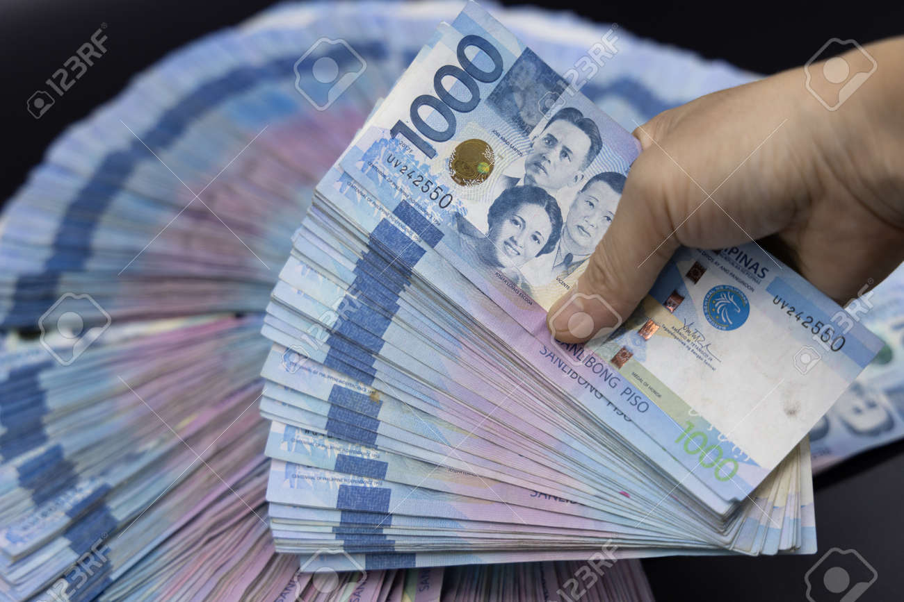 A Pile Of One Thousand Philippines Banknotes. Cash Of Thousand Dollar  Bills, Peso Background Image. Stock Photo, Picture and Royalty Free Image.  Image 169693062., image size:1300x867