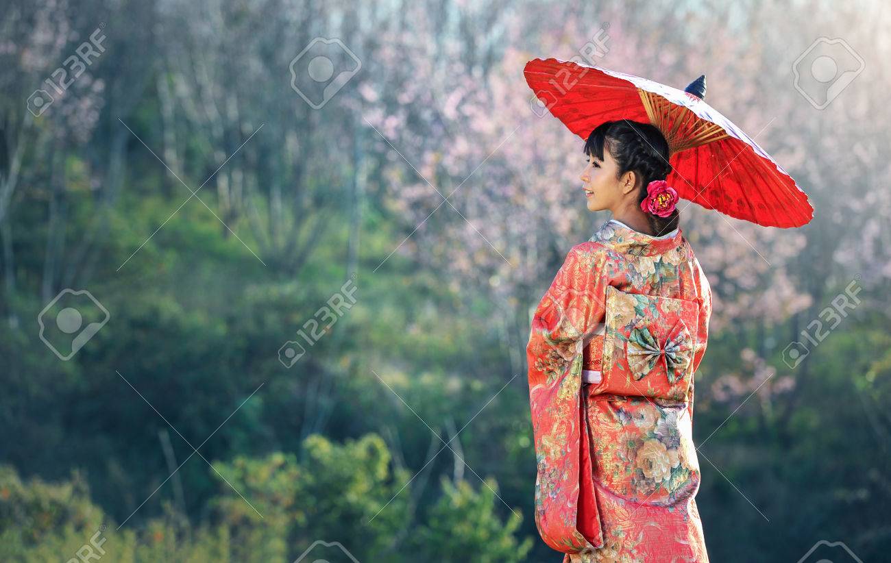 Asian woman wearing traditional japanese kimono, sakura background - 75553096 Asian woman wearing traditional japanese kimono, sakura background - 75553096