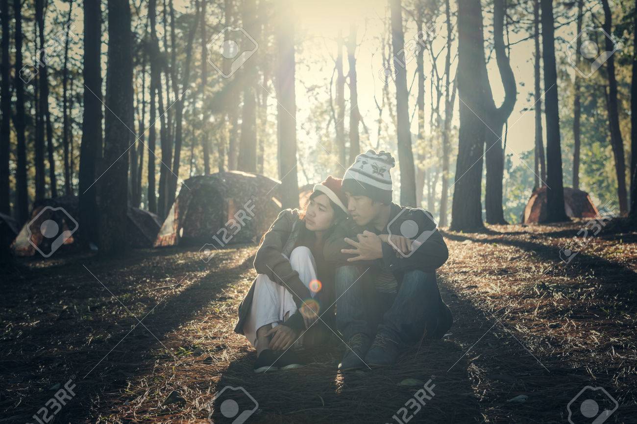 Antique Couple Sitting Under a Tree Photo