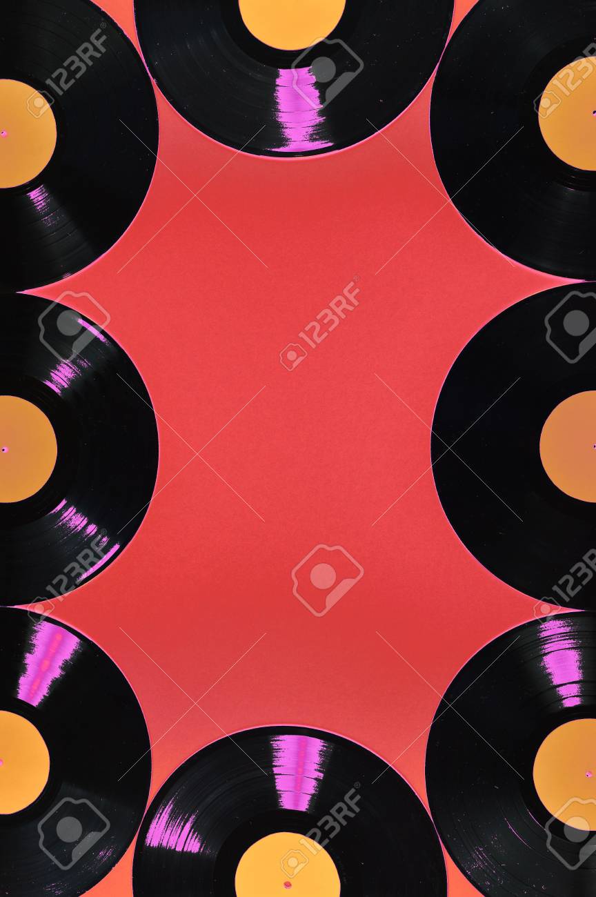old black vinyl records with blank orange labels on red background