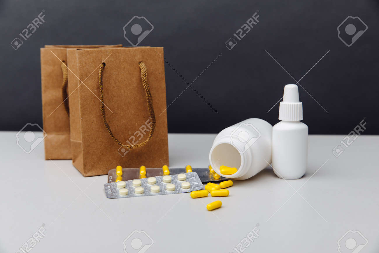 Online shoppng concept. Bags with compounded prescription medications shipped from a mail order pharmacy on a grey background - 169819163 Online shoppng concept. Bags with compounded prescription medications shipped from a mail order pharmacy on a grey background - 169819163