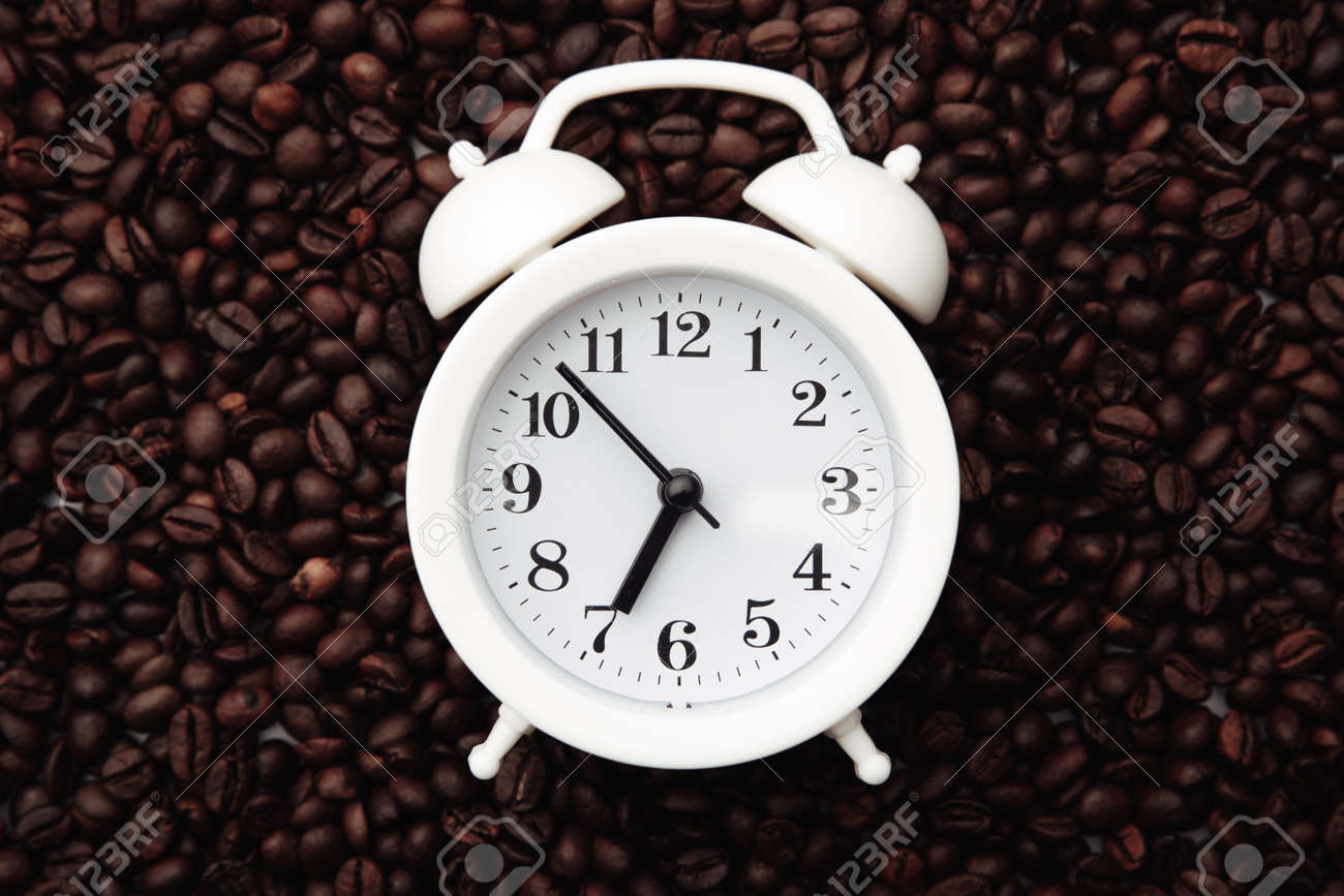 Alarm clock on coffee bean background - 169819549 Alarm clock on coffee bean background - 169819549